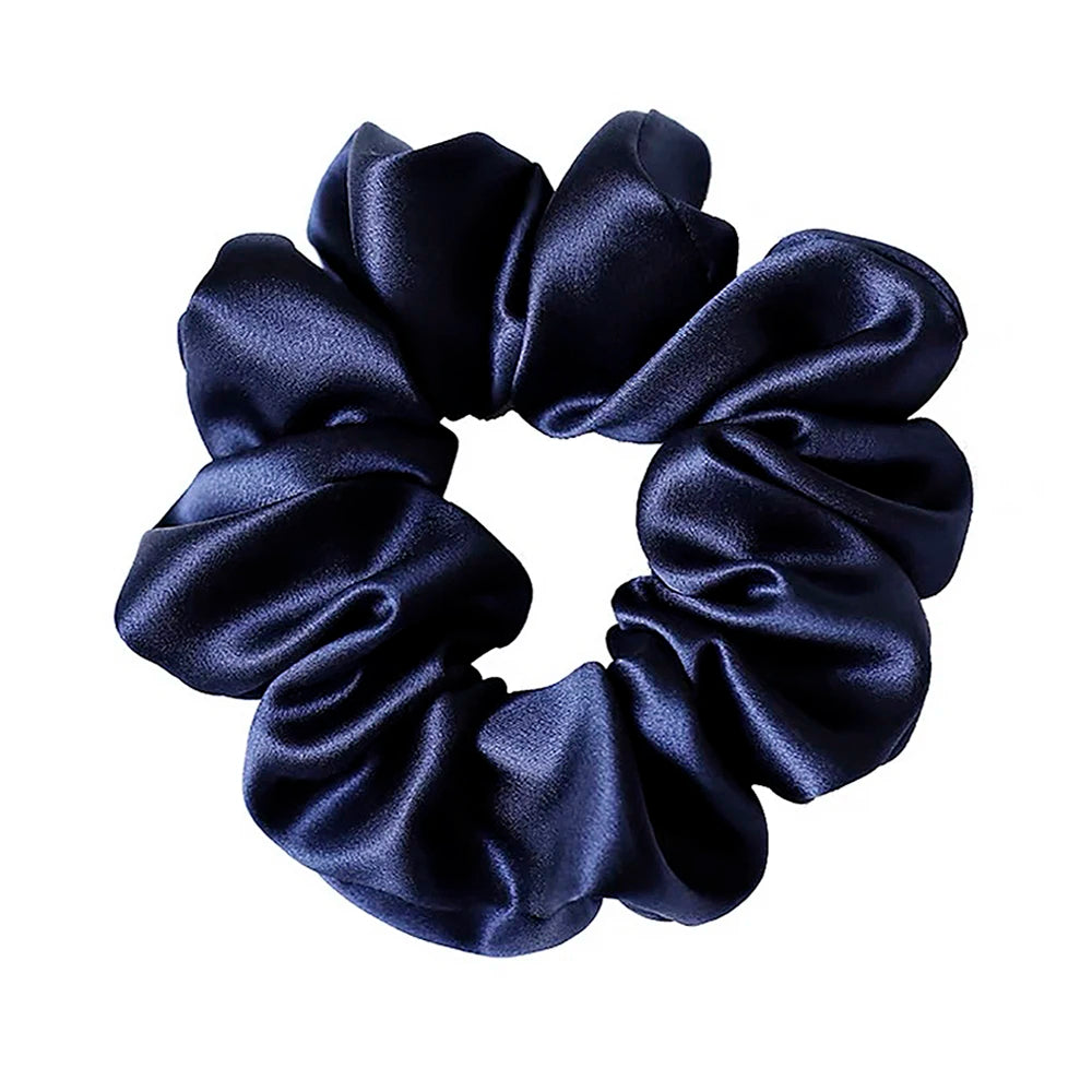 Navy blue satin scrunchie on a white background